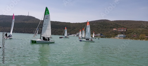 Yachting competitions on the lake on a clear spring day.