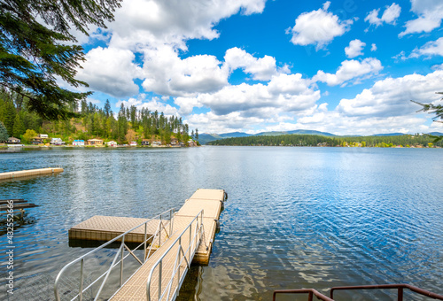 Obraz na plátně A small dock from a home in the rural community of Newman Lake, Washington, USA with other waterfront homes and boat slips in view