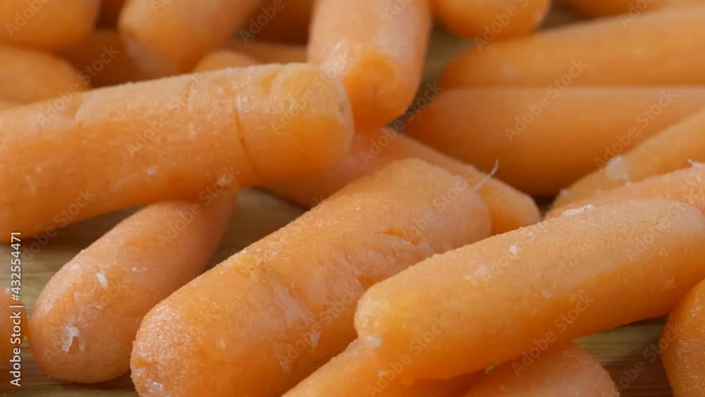 Slider shot of fresh carrots on a cutting board Slider shot of fresh carrots on a cutting board