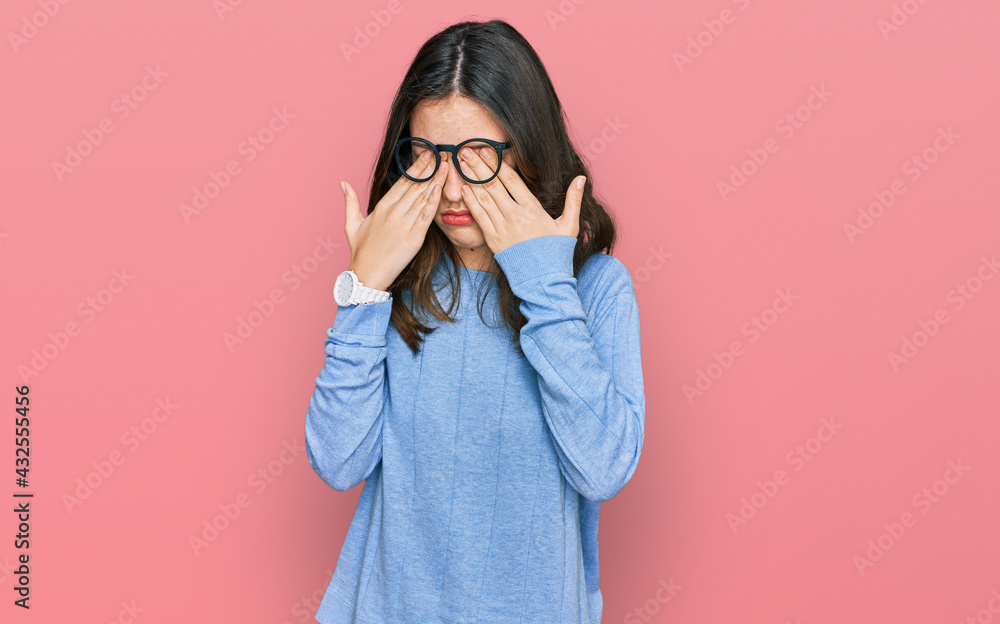 Young beautiful woman wearing casual clothes and glasses rubbing eyes for fatigue and headache, sleepy and tired expression. vision problem Young beautiful woman wearing casual clothes and glasses rubbing eyes for fatigue and headache, sleepy and tired expression. vision problem