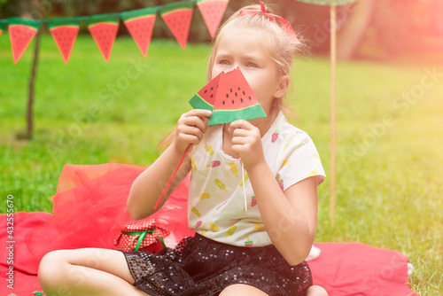 Watermelon party, picnic for children in park. watermelon day. Cute small girl.