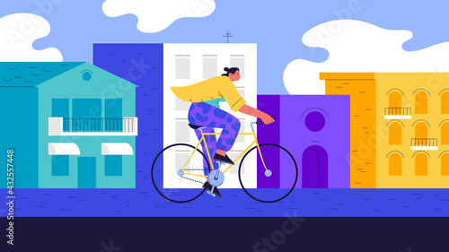 A woman wearing yellow t-shirt riding a fixed gear bicycle on the street of a city on a sunny day