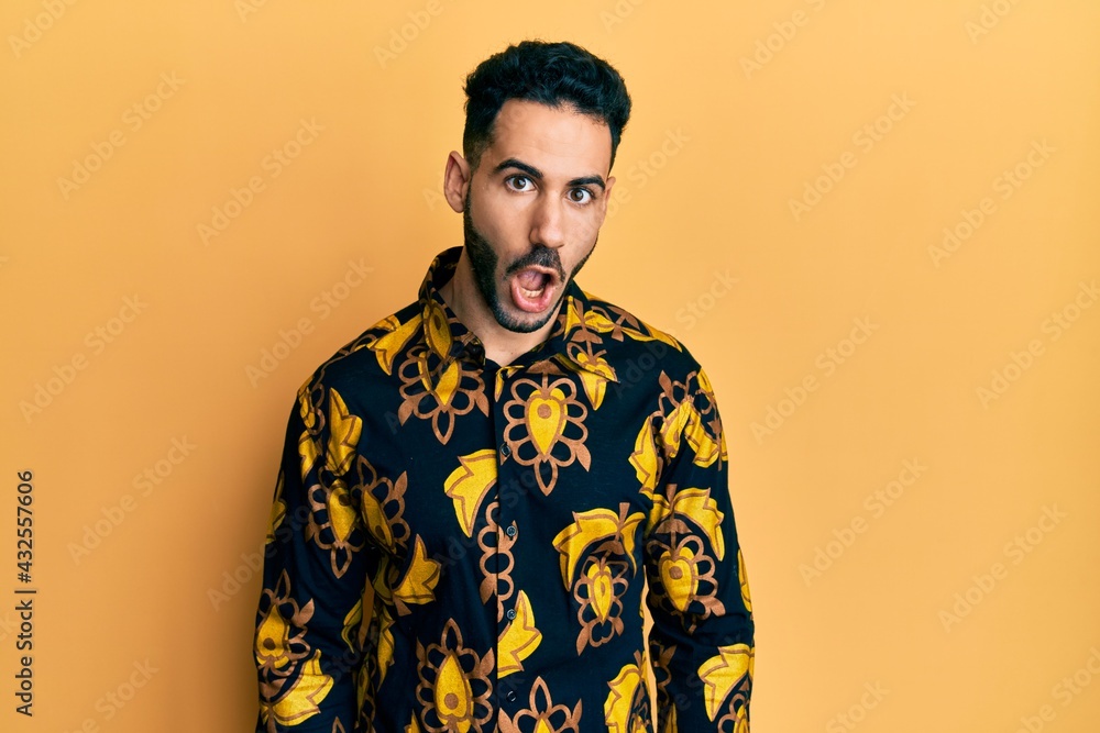 Young hispanic man wearing casual shirt afraid and shocked with surprise expression, fear and excited face. Young hispanic man wearing casual shirt afraid and shocked with surprise expression, fear and excited face.