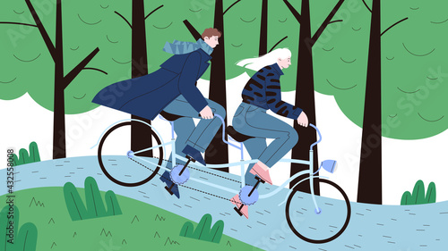 A couple on a date riding a tandem cruiser bicycle in the green park among the trees