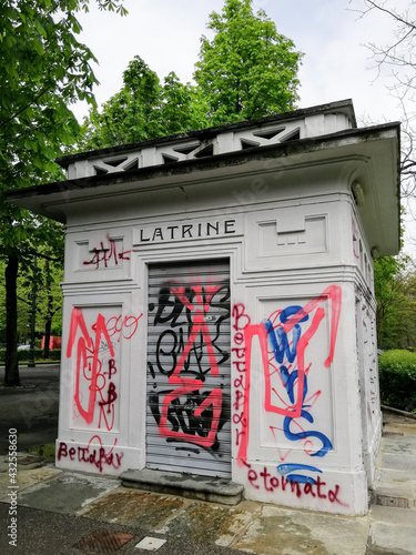 Art nouveau public toilets in a park in Turin, Italy, covered in graffiti