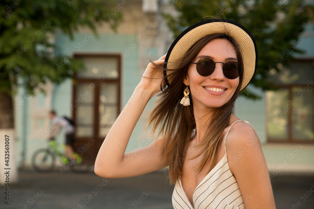 Beauty smiling model with natural makeup posing with hat in the city. Travel and lifestyle concept. Beauty smiling model with natural makeup posing with hat in the city. Travel and lifestyle concept.