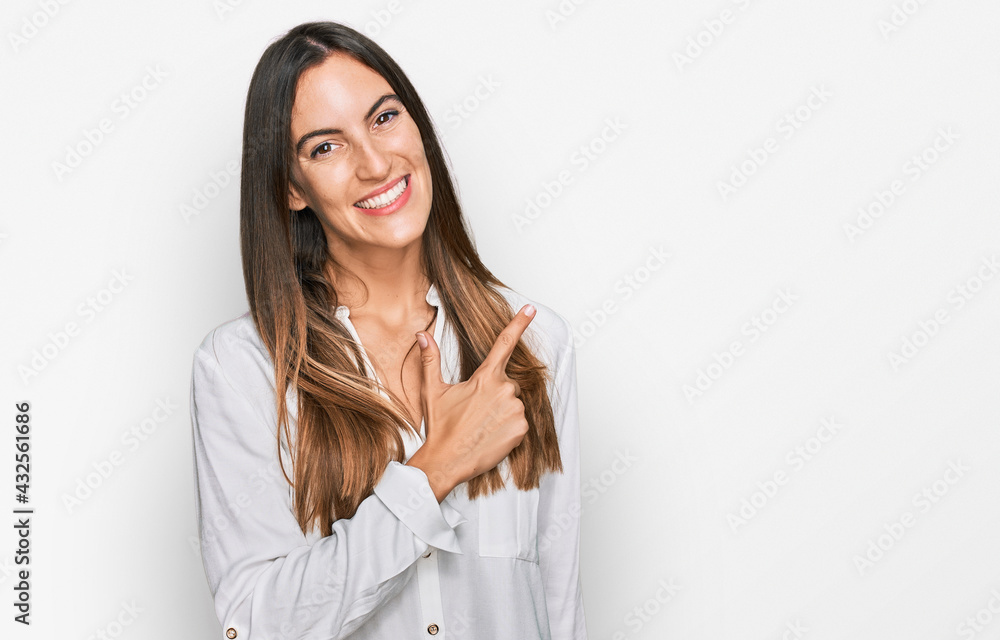 Young beautiful woman wearing casual clothes cheerful with a smile on face pointing with hand and finger up to the side with happy and natural expression Young beautiful woman wearing casual clothes cheerful with a smile on face pointing with hand and finger up to the side with happy and natural expression