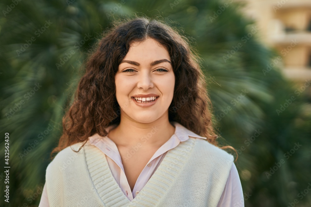 Young hispanic woman smiling happy standing at the park. Young hispanic woman smiling happy standing at the park.