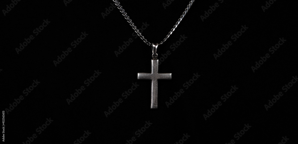 Praying with a rosary. hand of Catholic man with rosary on black background. Hands holding a silver rosary or cross pendant of Jesus Christ. Crucifix and hand on black background. Praying God concept Praying with a rosary. hand of Catholic man with rosary on black background. Hands holding a silver rosary or cross pendant of Jesus Christ. Crucifix and hand on black background. Praying God concept