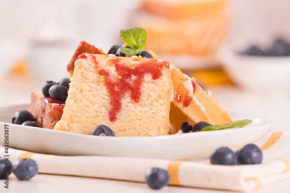 Lemon pund cake with blueberries and strawberry syrup.