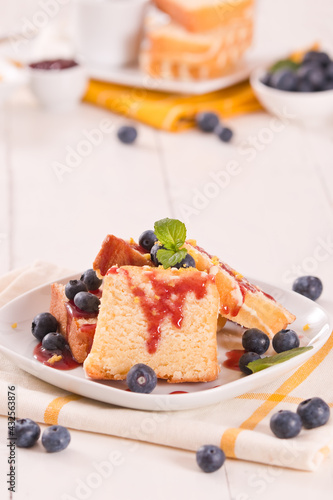 Lemon pund cake with blueberries and strawberry syrup.