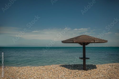 Wooden beach umbrellas by the sea in clear weather © sun_house_ann