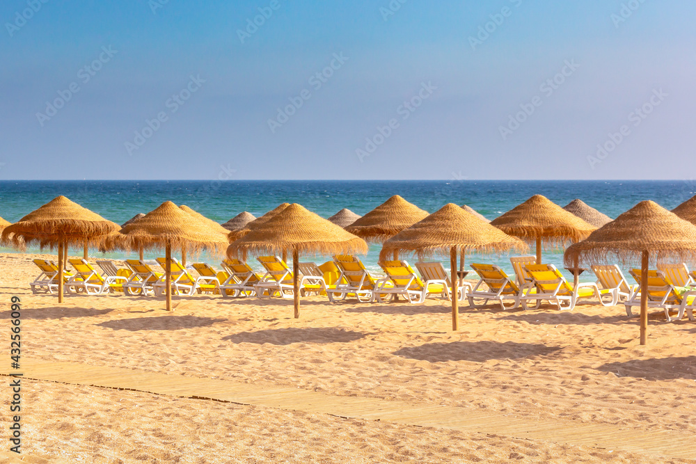 Lounge chairs and parasols on Albufeira beach, Algarve, Portugal