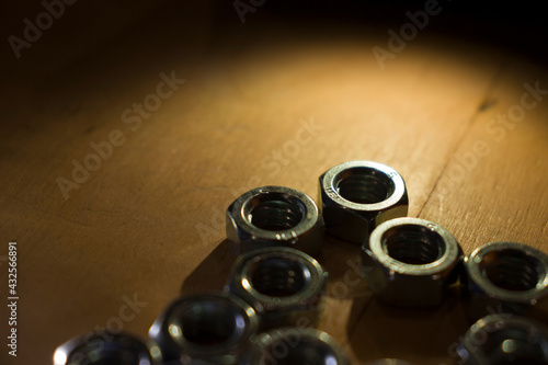 screw nuts on a wooden table