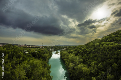 Heavy Clouds Over Soca River With Bicycle Bridge