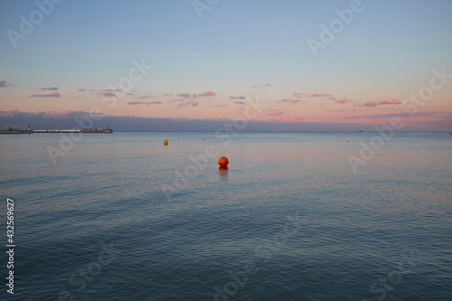 Beautiful calm evening sea with red buoy