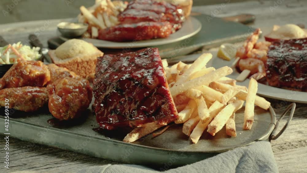 Ribs and Chicken Drumsticks near French Fries on a Rustic Antique Platter Ribs and Chicken Drumsticks near French Fries on a Rustic Antique Platter