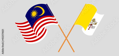 Crossed and waving flags of Malaysia and Vatican
