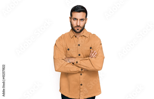 Young hispanic man wearing casual clothes skeptic and nervous, disapproving expression on face with crossed arms. negative person. © Krakenimages.com