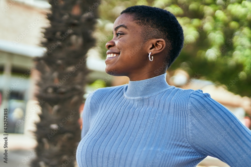 Young african american woman smiling happy standing at the city. Young african american woman smiling happy standing at the city.