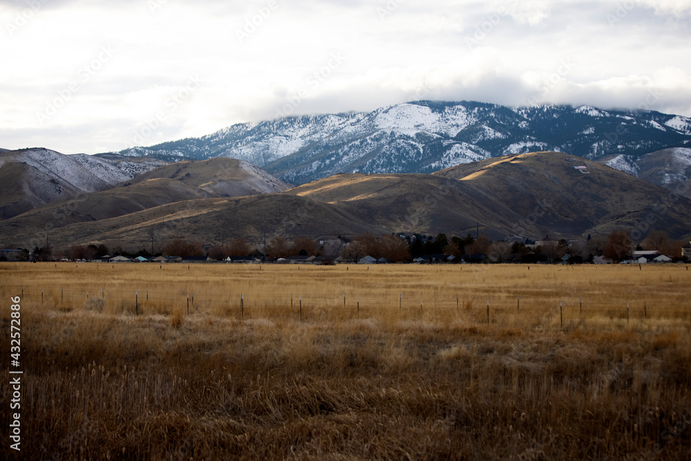 Field of dried grasses before C hill lit with a strip of light in carson city nevada