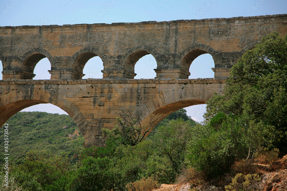 Fototapeta premium Pont du Gard, Gard, Occitanie, France: Roman aqueduct over Gardon river: close-up detail of upper tiers of arches