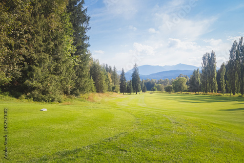 A summer day at Kokanee Springs Golf Resort golf course with view of Selkirk Mountains in Crawford Bay, British Columbia, Canada. photo