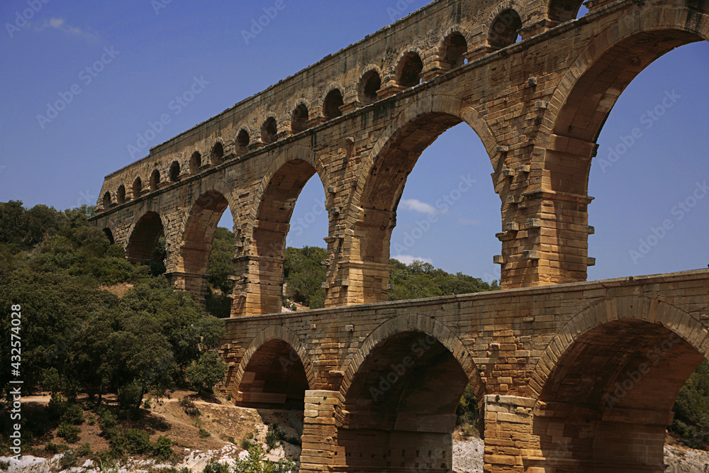 Pont du Gard, Gard, Occitanie, France: Roman aqueduct over Gardon river: close-up detail of the upper tiers of arches