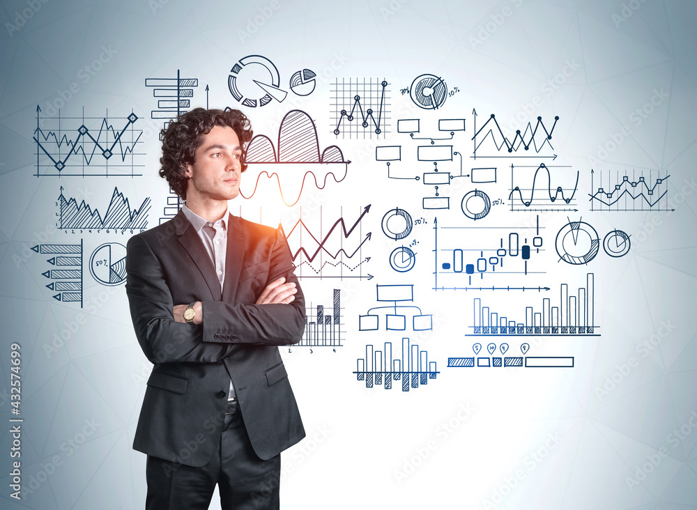 Businessman in black suit standing on background of graph sketch Businessman in black suit standing on background of graph sketch