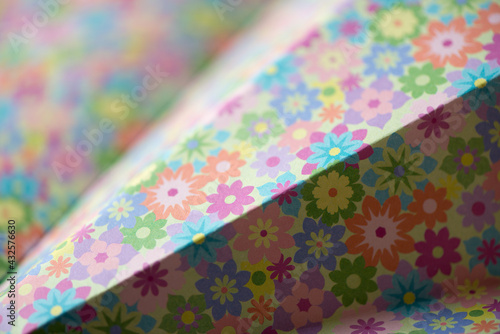 folded floral scrapbooking paper photographed using a macro lens, featuring a shallow depth of field