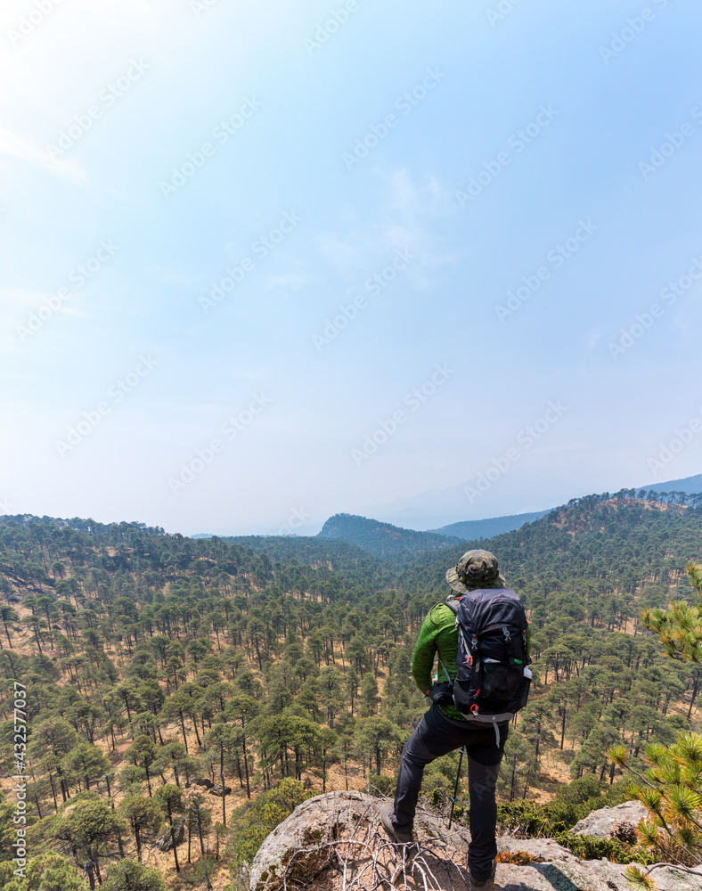 Vertical shot of a Hispanic hiker on top of Mount Tlaloc in Mexico Vertical shot of a Hispanic hiker on top of Mount Tlaloc in Mexico