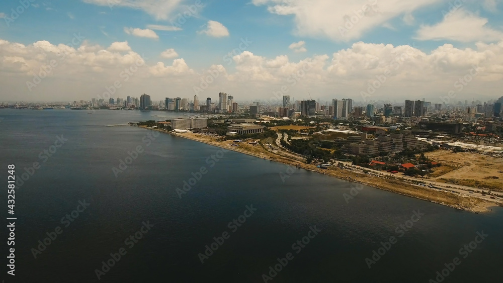 Aerial view of Manila city. Fly over city with skyscrapers and buildings. Aerial skyline of Manila . Modern city by sea, highway, cars, skyscrapers, shopping malls. Makati district. Travel concept. Aerial view of Manila city. Fly over city with skyscrapers and buildings. Aerial skyline of Manila . Modern city by sea, highway, cars, skyscrapers, shopping malls. Makati district. Travel concept.