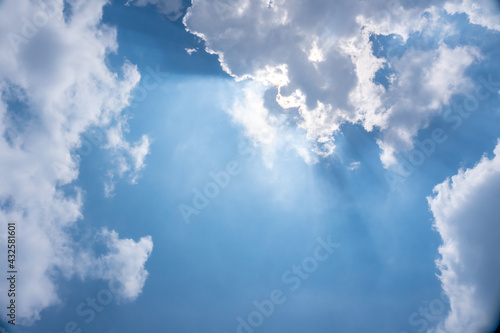 Beautiful shot of sunlight shining through clouds in a blue sky