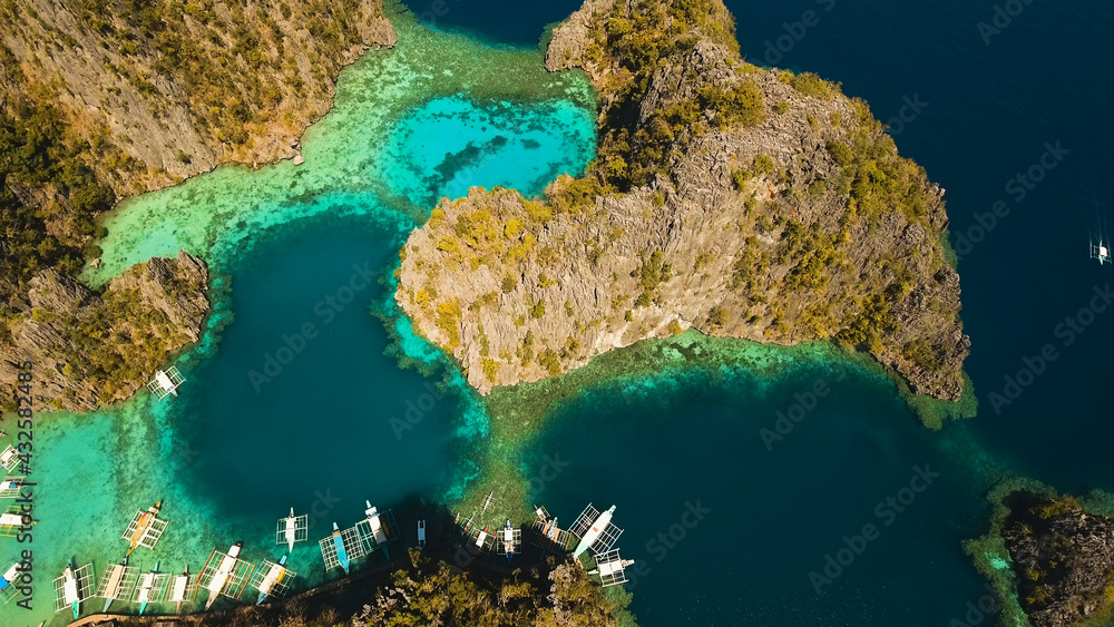 Tropical lagoon with azure water, beach by the Kayangan Lake, Philippines. Aerial view Coron island, with cove, bay at Kayangan lake. Lagoon with sailing boats. Aerial video. Philippines. Travel