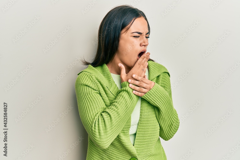 Young brunette woman wearing casual clothes bored yawning tired covering mouth with hand. restless and sleepiness. Young brunette woman wearing casual clothes bored yawning tired covering mouth with hand. restless and sleepiness.