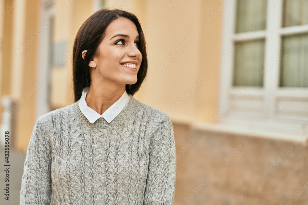 Young hispanic woman smiling happy standing at the city. Young hispanic woman smiling happy standing at the city.