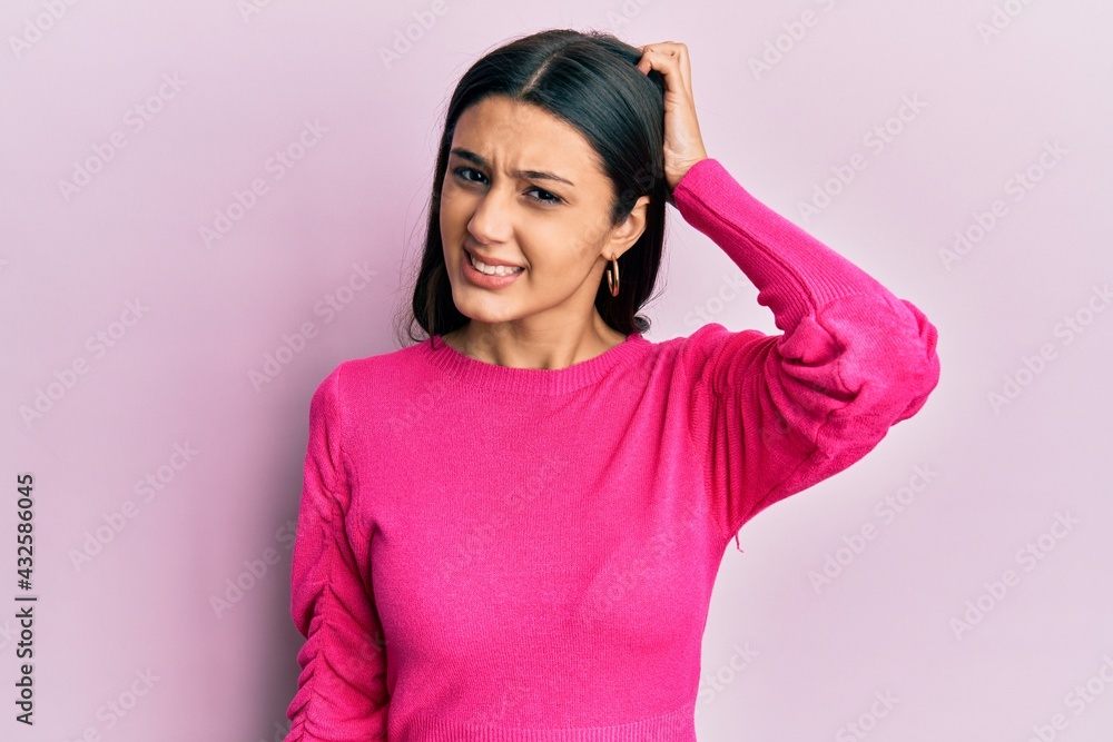 Young hispanic woman wearing casual clothes confuse and wonder about question. uncertain with doubt, thinking with hand on head. pensive concept. Young hispanic woman wearing casual clothes confuse and wonder about question. uncertain with doubt, thinking with hand on head. pensive concept.