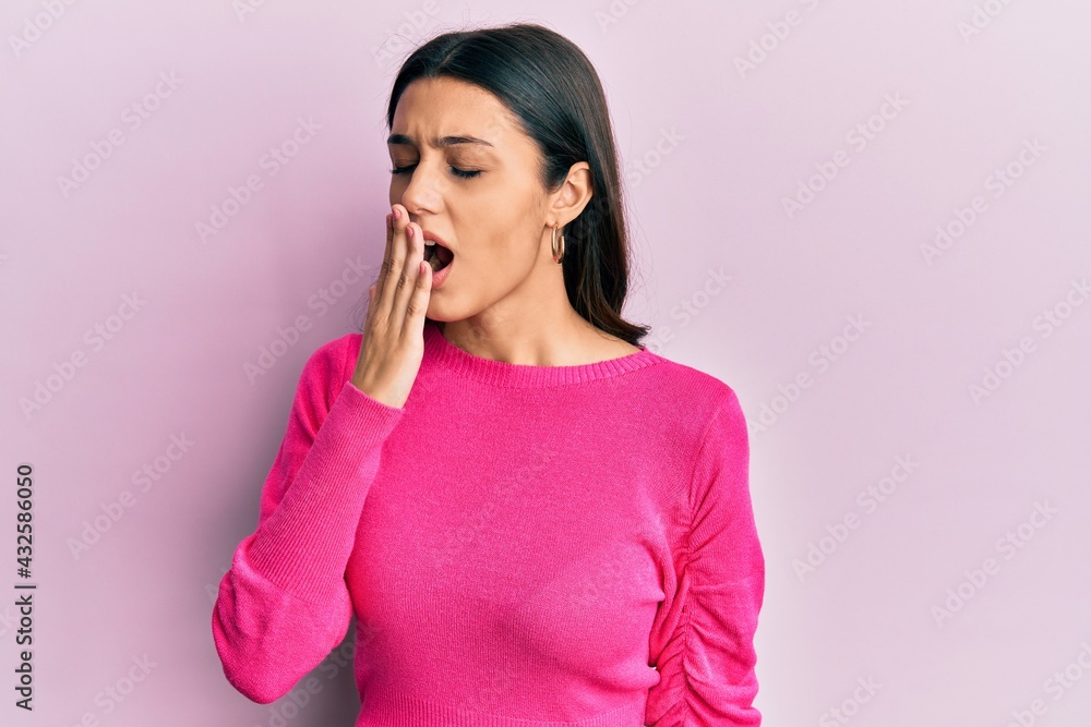Young hispanic woman wearing casual clothes bored yawning tired covering mouth with hand. restless and sleepiness. Young hispanic woman wearing casual clothes bored yawning tired covering mouth with hand. restless and sleepiness.