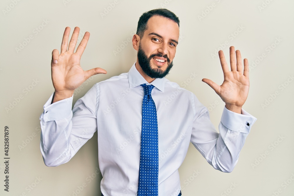 Young man with beard wearing business tie showing and pointing up with fingers number nine while smiling confident and happy. Young man with beard wearing business tie showing and pointing up with fingers number nine while smiling confident and happy.