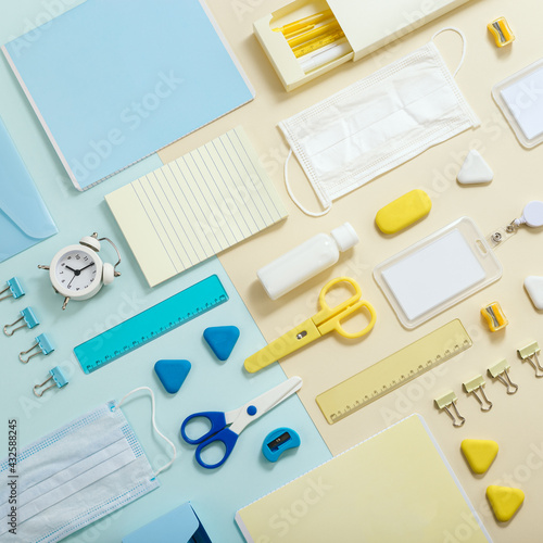 Stationary school supplies in yellow and blue tone. Office accessories and personal protective equipments © yrabota