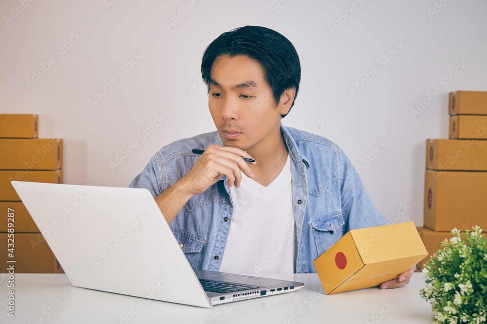Online Merchant or Casual Businessman in Online Store Hold Parcel and Think about Shipping Cost in Vintage Tone Online Merchant or Casual Businessman in Online Store Hold Parcel and Think about Shipping Cost in Vintage Tone