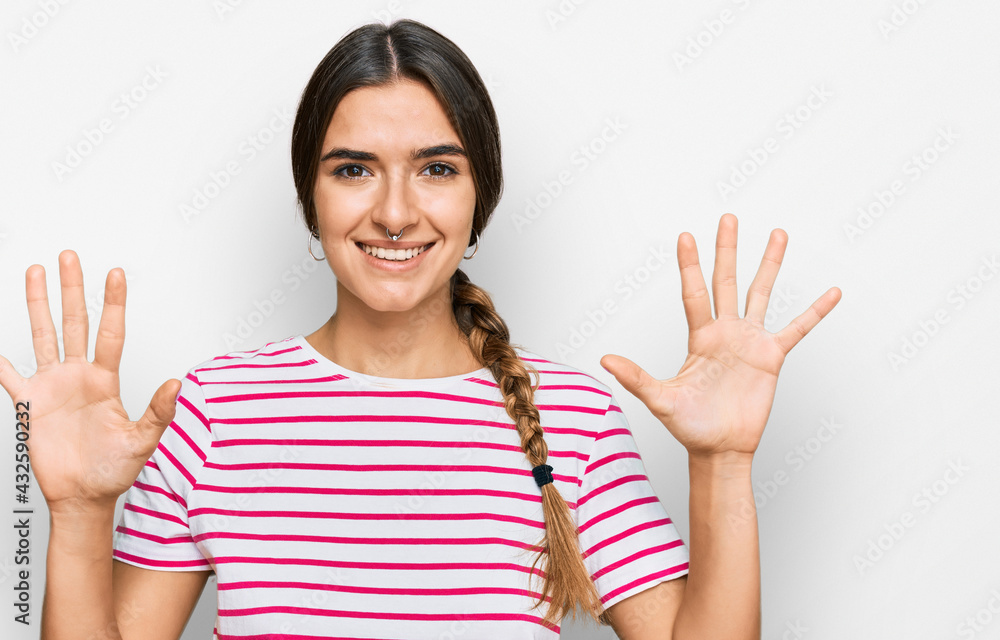 Young hispanic woman wearing casual clothes showing and pointing up with fingers number ten while smiling confident and happy. Young hispanic woman wearing casual clothes showing and pointing up with fingers number ten while smiling confident and happy.