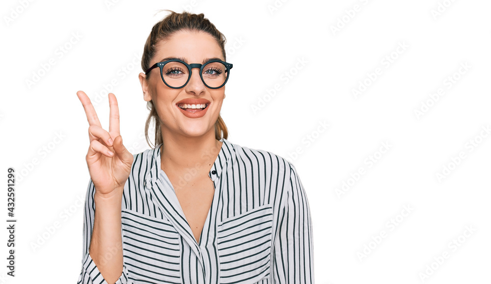 Young caucasian woman wearing business shirt and glasses showing and pointing up with fingers number two while smiling confident and happy. Young caucasian woman wearing business shirt and glasses showing and pointing up with fingers number two while smiling confident and happy.