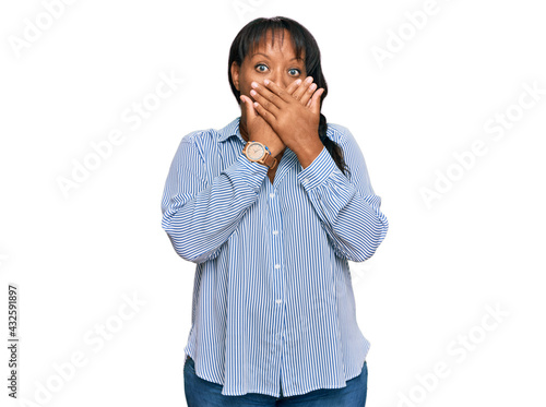 Hispanic middle age woman wearing casual clothes shocked covering mouth with hands for mistake. secret concept.