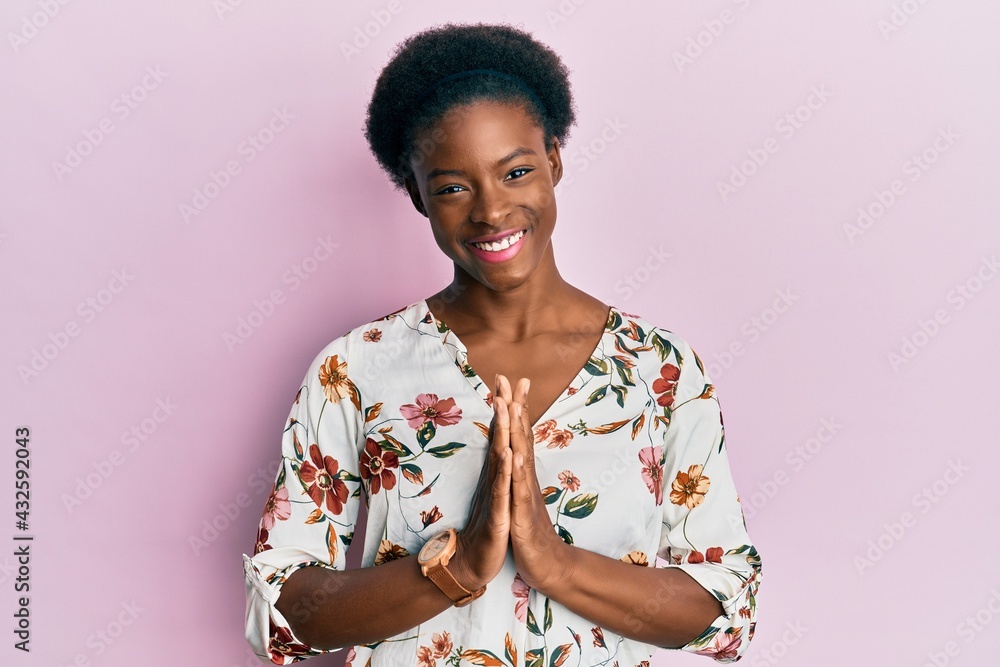 Young african american girl wearing casual clothes praying with hands together asking for forgiveness smiling confident. Young african american girl wearing casual clothes praying with hands together asking for forgiveness smiling confident.