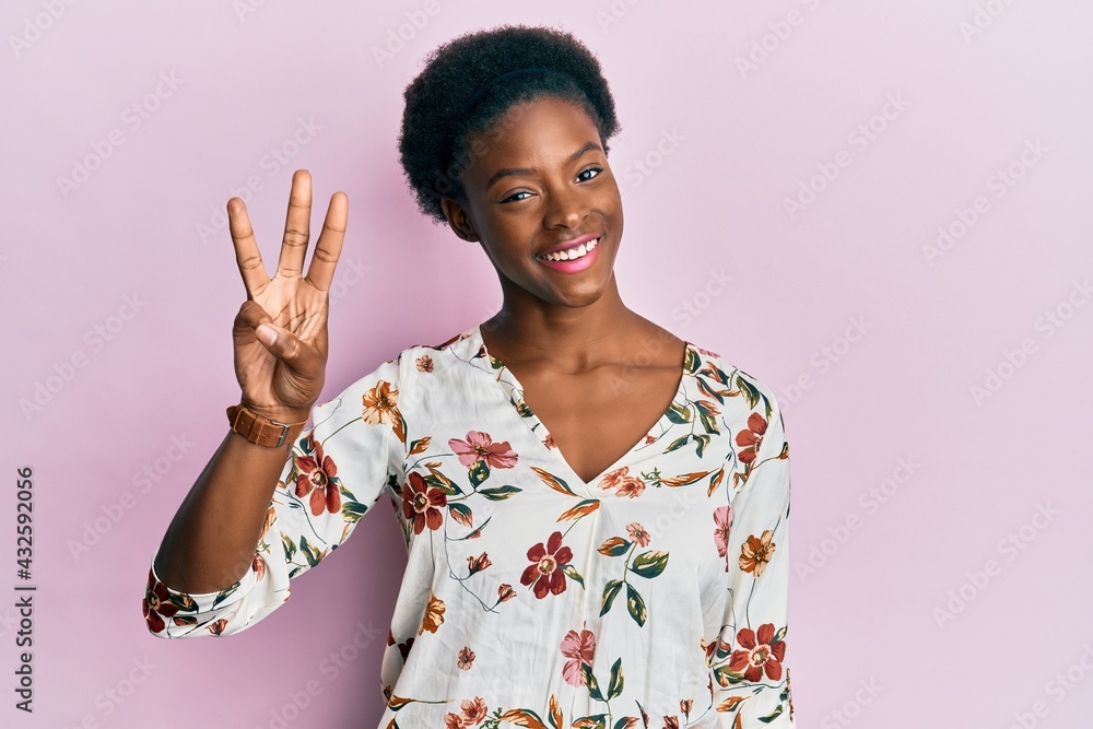 Young african american girl wearing casual clothes showing and pointing up with fingers number three while smiling confident and happy. Young african american girl wearing casual clothes showing and pointing up with fingers number three while smiling confident and happy.
