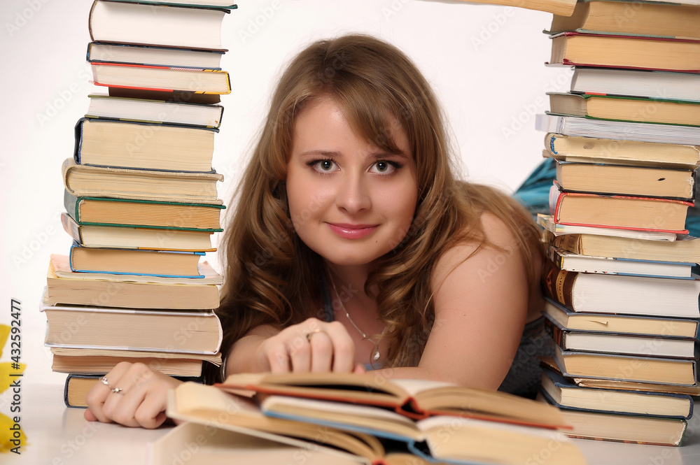 blonde student in the studio among the many books blonde student in the studio among the many books