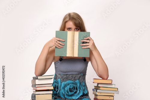 blonde student in the studio among the many books