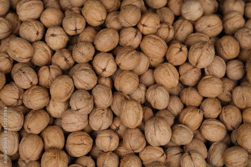top down view of heap of brown walnuts background top down view of heap of brown walnuts background