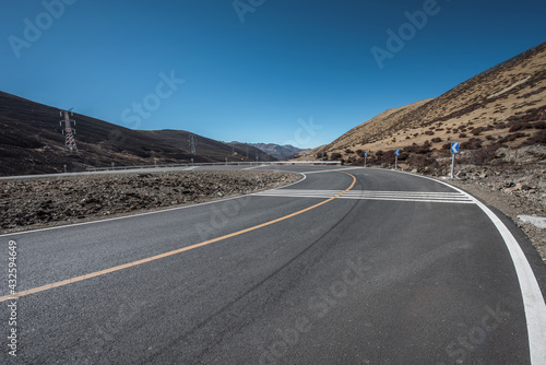 An open road under a snowy mountain